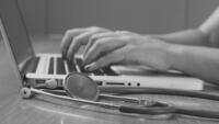 black and white image of Healthcare professional on laptop